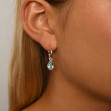 Fine open hoop studs with pear shaped blue topaz