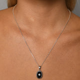 Adjustable necklace with oval black onyx & blue topaz charm